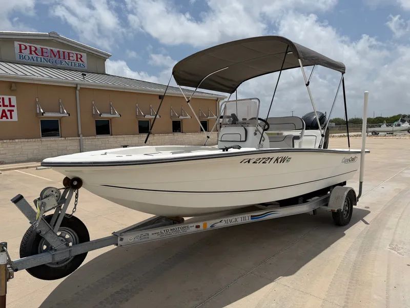 Slide: The Image of A white 2016 Cape Craft 180cc boat on a trailer in front of a building. - 3