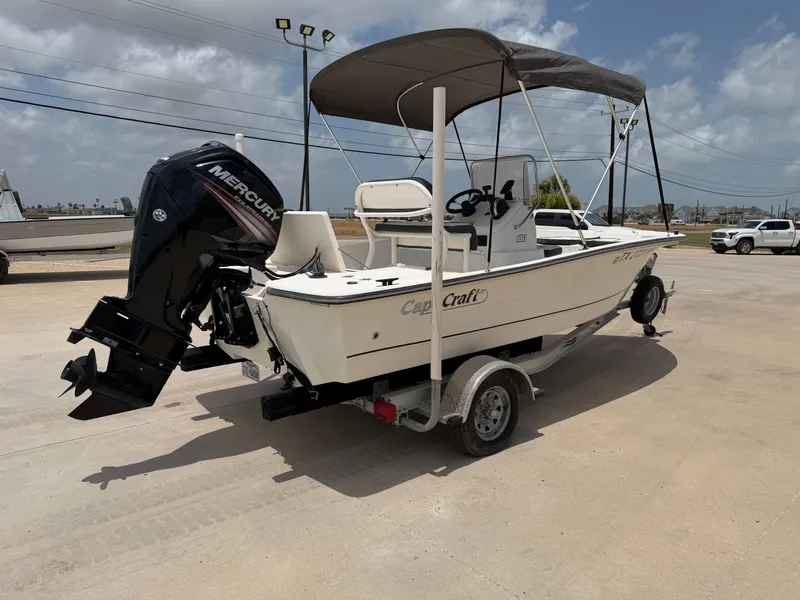 Slide: The Image of A 2016 Cape Craft 180cc boat on a trailer. It features a sunshade and a Mercury outboard motor. - 8