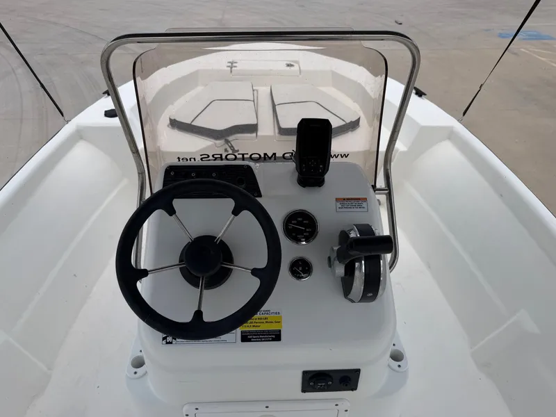 Slide: The Image of The image shows the helm of a 2016 Cape Craft 180cc boat with a steering wheel and instruments. - 20