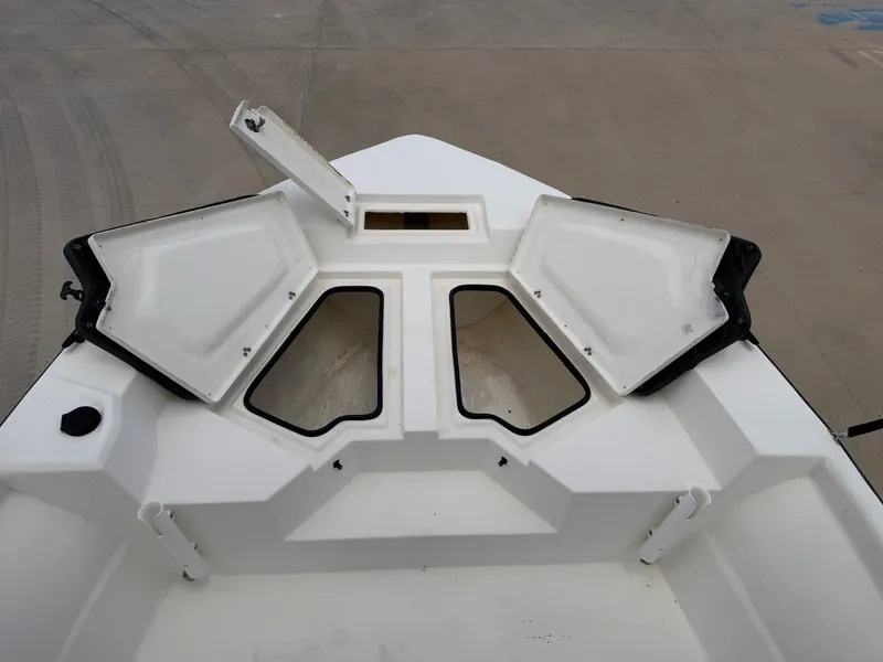 Slide: The Image of The image shows the bow of a 2016 Cape Craft 180cc boat with open storage compartments. - 13