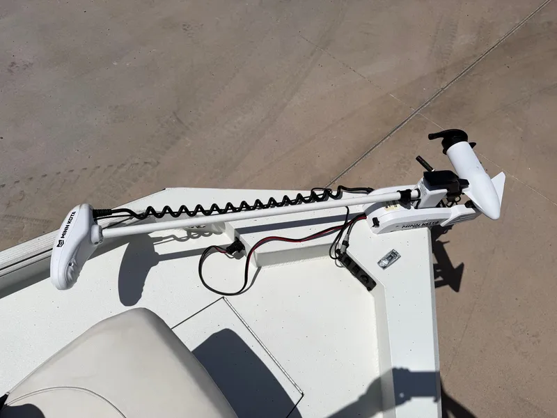 Slide: The Image of A white trolling motor is mounted on the bow of a boat, with a seat nearby. - 18