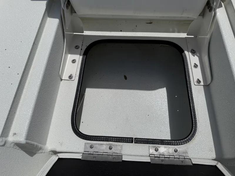 Slide: The Image of An open storage compartment on a 2023 Excel 203 Bay Pro boat, featuring a black sealing ring. - 30
