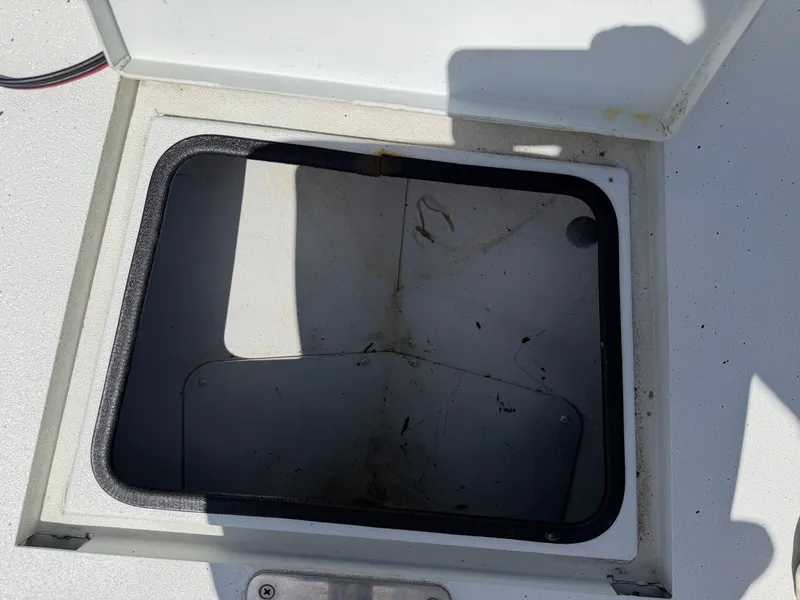 Slide: The Image of An open storage compartment on a boat, surrounded by a white surface. - 17