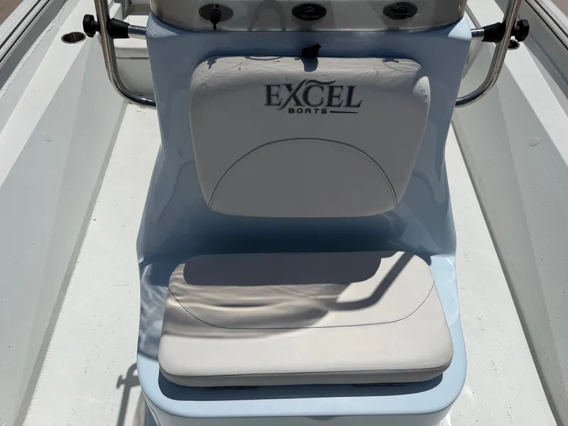 Slide: The Image of A white seat with "Excel Boats" logo on a boat. The seat has a backrest and cushion. - 20