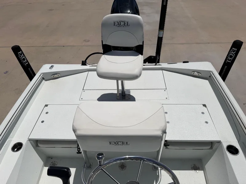 Slide: The Image of The image shows the cockpit of an Excel 203 Bay Pro boat with two white seats. - 25