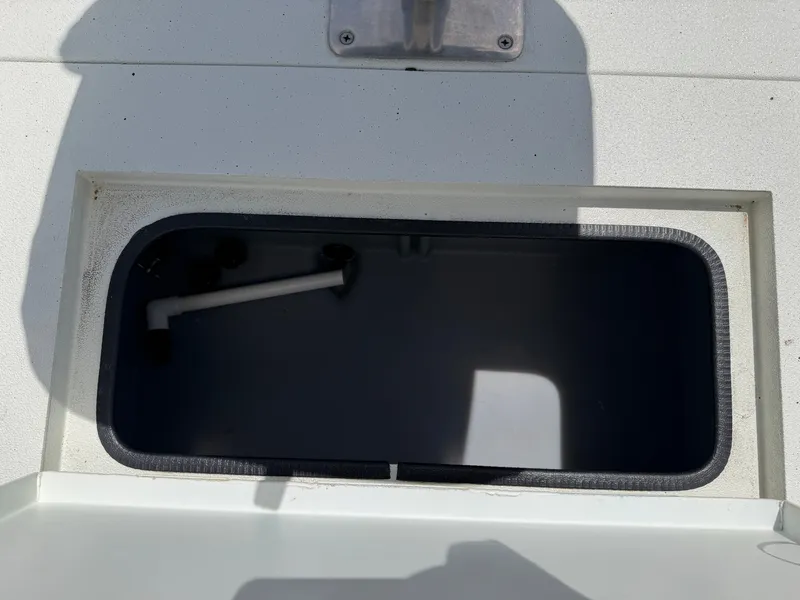Slide: The Image of An open storage compartment on a boat with a pipe inside. - 29