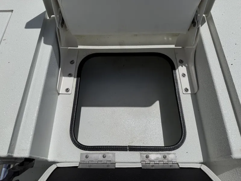 Slide: The Image of An open storage compartment on a boat with a sturdy, rectangular frame and hinges. - 28