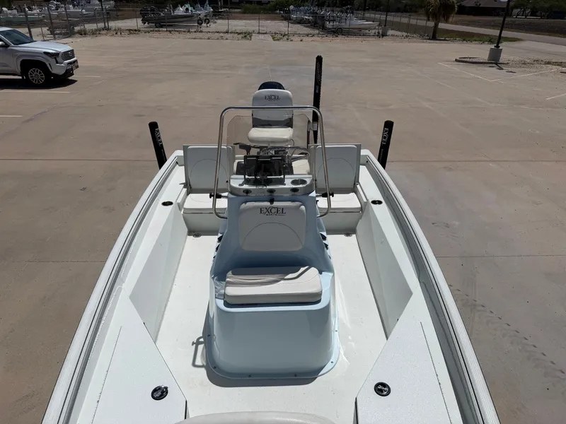 Slide: The Image of The image shows a 2023 Excel 203 Bay Pro boat on a parking lot. It features a central console and seating. - 19