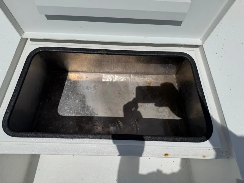 Slide: The Image of An open storage compartment on a boat with a metal bottom. - 15