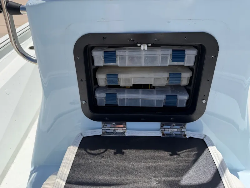 Slide: The Image of An open storage compartment on a boat with two plastic boxes. - 22