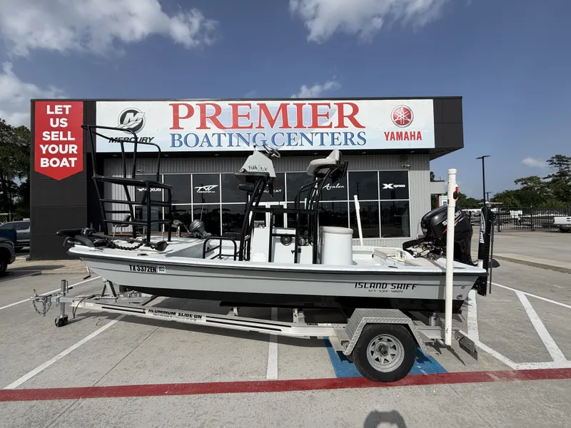 The Image of A 2016 Exuma 17 Island Skiff on a trailer in front of a boating center. - 1