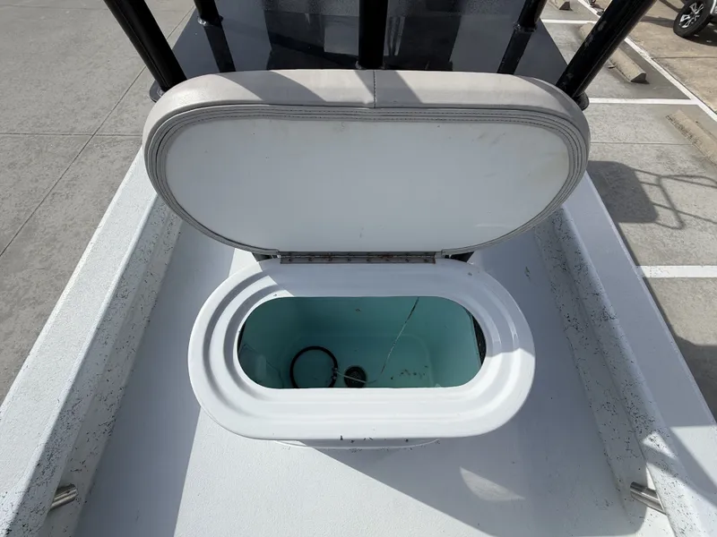 Slide: The Image of An open storage compartment on a 2016 Exuma 17 Island Skiff, parked in a lot. - 14