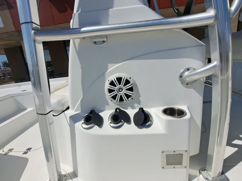 Slide: The Image of The image shows the helm of a Sea Hunt XP21 boat with a speaker and holders. - 28