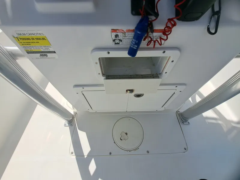 Slide: The Image of The image shows the cockpit of a 2011 Sea Hunt XP21 with storage and controls. - 25