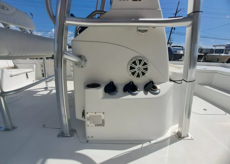 Slide: The Image of The image shows the cockpit of a 2011 Sea Hunt XP21 boat with a helm console and speaker. - 29