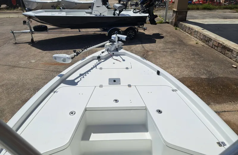 Slide: The Image of The image shows the deck of a 2011 Sea Hunt XP21 boat parked on a lot. - 12