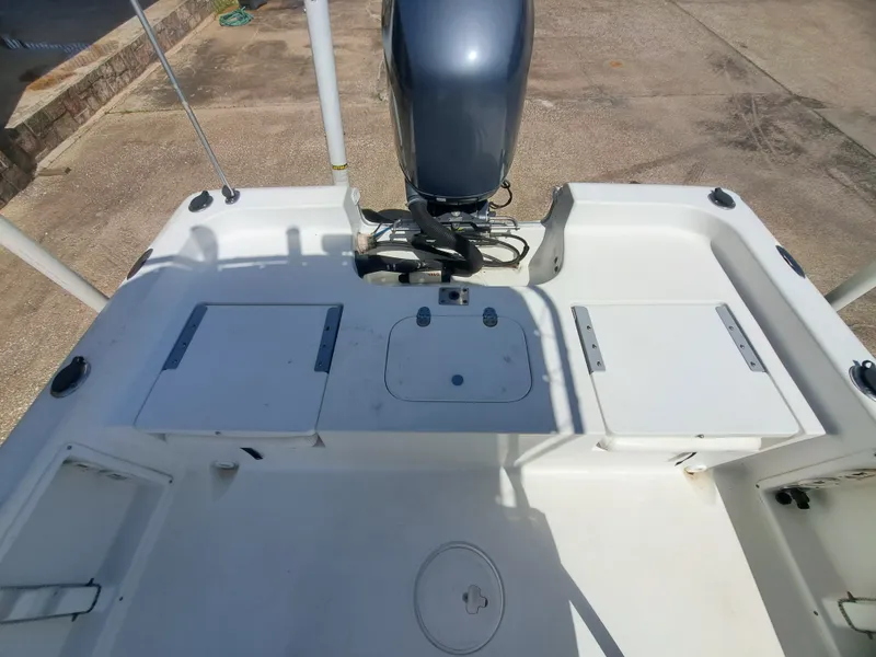 Slide: The Image of The image shows the stern of a 2011 Sea Hunt XP21 boat with an outboard motor. - 17