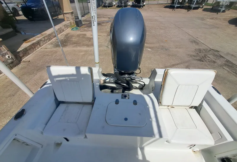 Slide: The Image of The image shows the stern of a 2011 Sea Hunt XP21 boat with an outboard motor. - 19