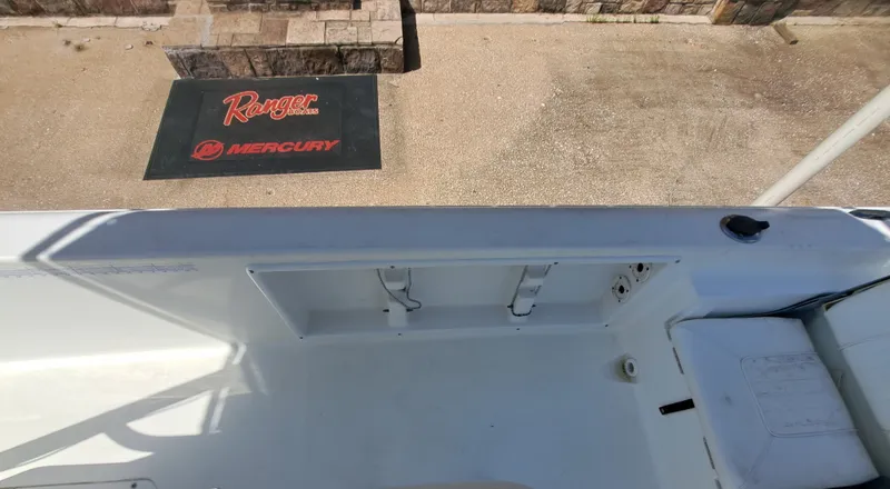 Slide: The Image of The image shows the deck of a 2011 Sea Hunt XP21 boat with a clean, white surface. - 21