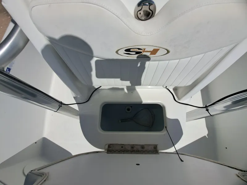 Slide: The Image of The image shows the interior of a 2011 Sea Hunt XP21 boat with a storage compartment. - 16