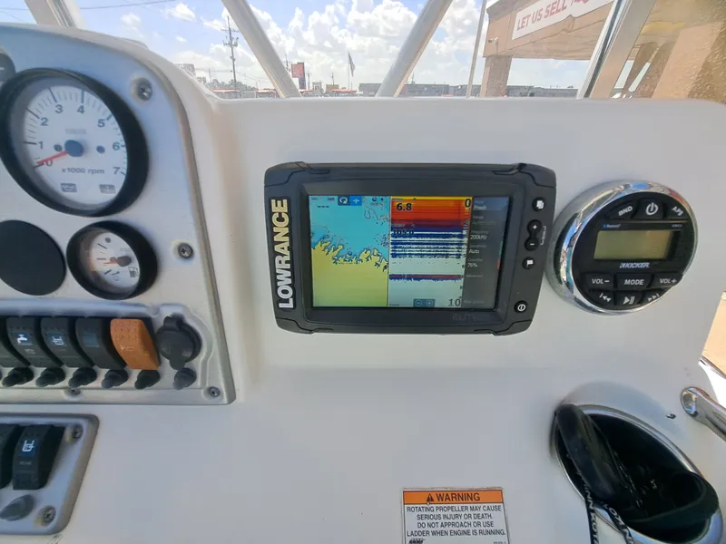 Slide: The Image of The image shows the dashboard of a 2011 Sea Hunt XP21 boat with a Lowrance fish finder. - 26