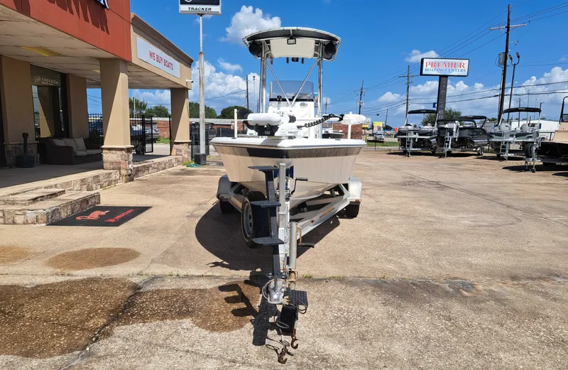 Slide: The Image of A 2011 Sea Hunt XP21 boat on a trailer in front of a store. - 3