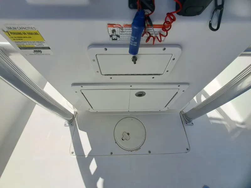 Slide: The Image of The image shows the cockpit of a 2011 Sea Hunt XP21 boat with storage compartments and controls. - 24