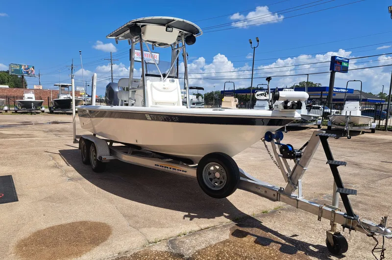 Slide: The Image of A white 2011 Sea Hunt XP21 boat on a trailer in a parking lot. - 5