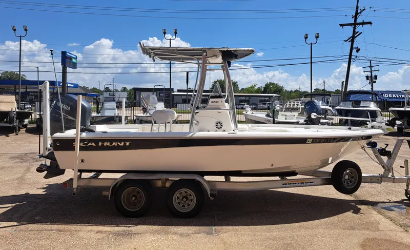 Slide: The Image of A white 2011 Sea Hunt XP21 boat on a trailer in an outdoor setting. - 9