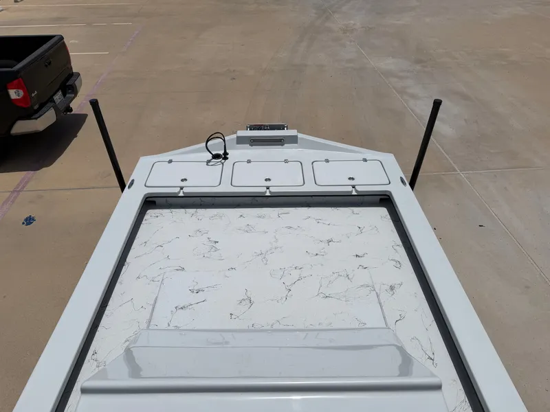 Slide: The Image of The image shows the deck of a 2027 Shoalwater 23 CAT RSD boat with storage hatches. - 15