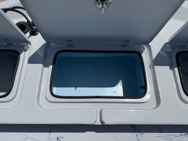 Slide: The Image of An open storage compartment on a boat with a blue interior and a lid with a lock. - 23