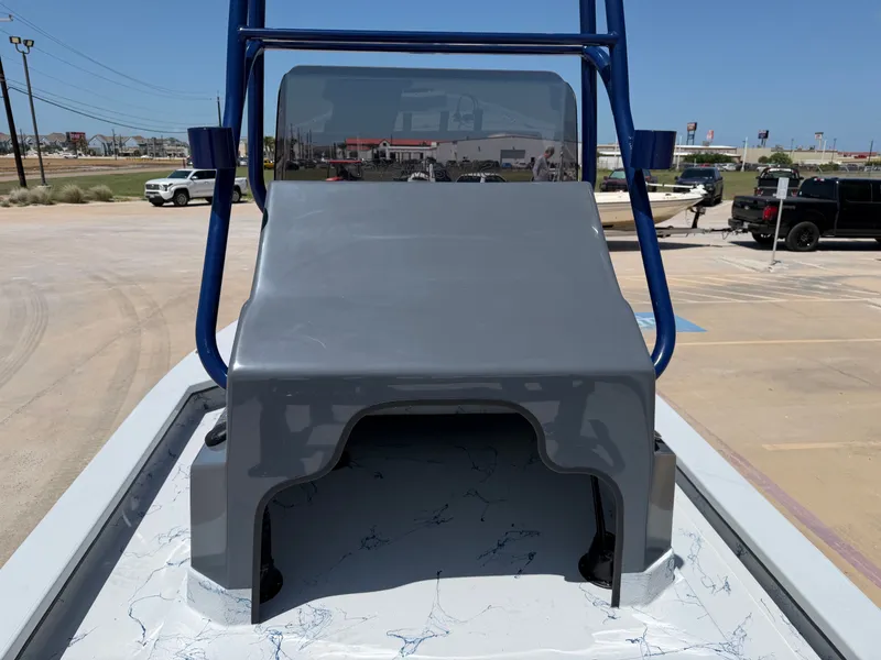 Slide: The Image of The image shows the deck of a 2027 Shoalwater 23 CAT RSD boat with a blue railing. - 19