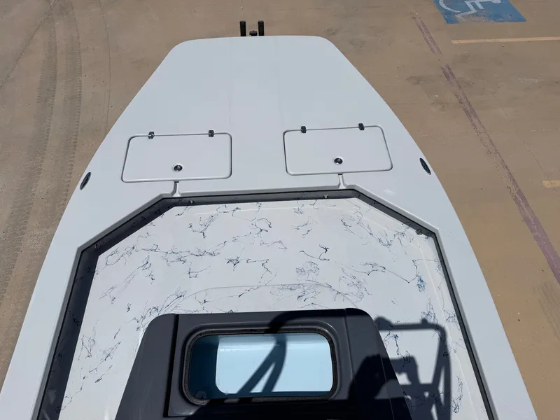 Slide: The Image of The image shows the deck of a 2027 Shoalwater 23 CAT RSD boat with two hatches. - 16
