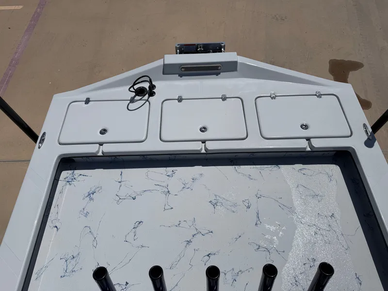 Slide: The Image of The image shows the deck of a Shoalwater 23 CAT RSD boat with multiple storage compartments. - 21
