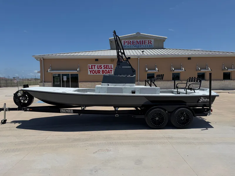 The Image of A 2027 Shoalwater 23' Catamaran on a trailer in front of a boating center. - 1