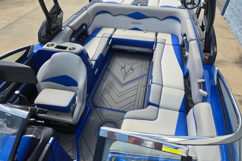 Slide: The Image of 2017 Supra SG 400-550 boat interior with blue and gray seating, cup holders, and sleek design. - 16