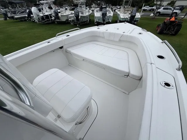 Slide: The Image of The image shows the cockpit of a Parker 210 Coastal boat with white upholstery and seating. - 7