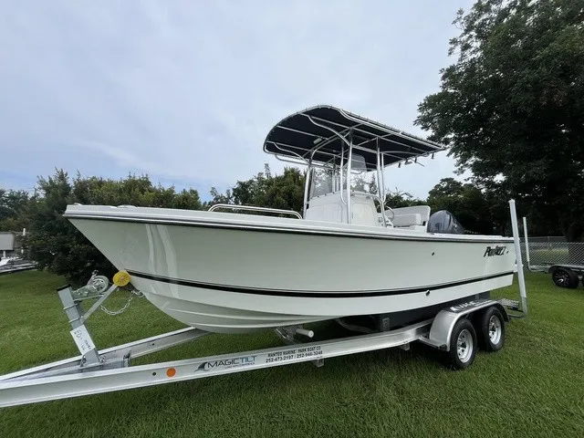 The Image of A 2027 Parker 210 Coastal boat on a trailer, set on a grassy field. - 1