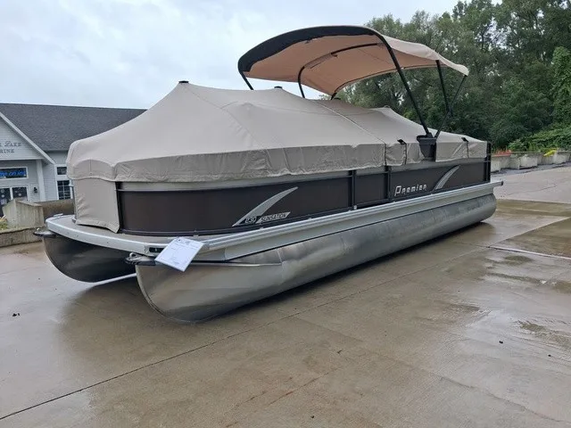 Slide: The Image of A 2015 Premier Sunsation RF 230 pontoon boat with cover and canopy on a concrete lot. - 18