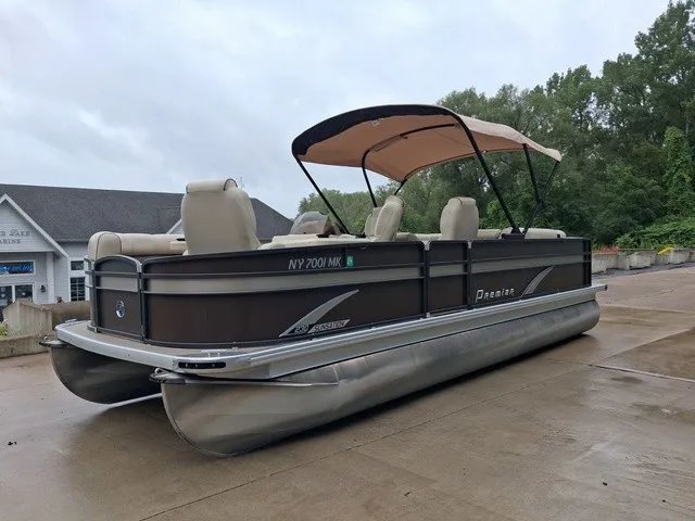 The Image of A 2015 Premier Sunsation RF 230 pontoon boat on concrete. It features a sun canopy. - 1
