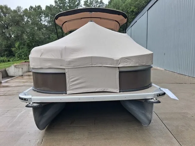 Slide: The Image of A 2015 Premier Sunsation RF 230 pontoon boat with a cover, parked on a concrete lot. - 17