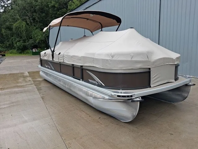 Slide: The Image of A 2015 Premier Sunsation RF 230 pontoon boat with a cover, on concrete next to a building. - 16