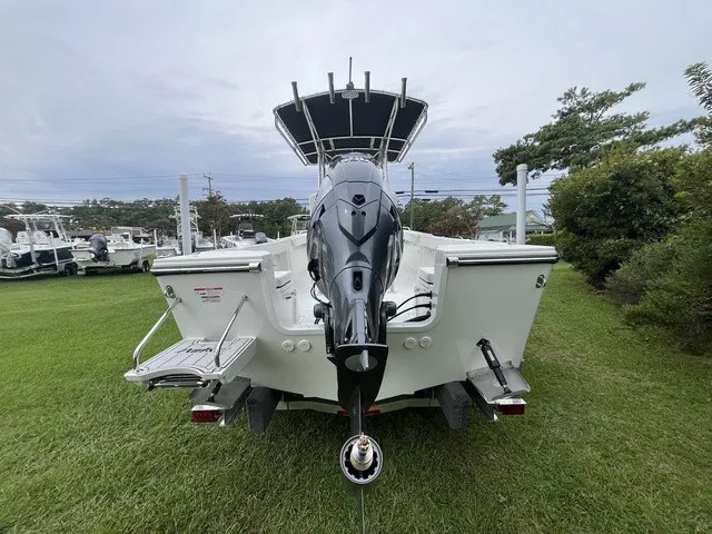 Slide: The Image of The image shows a 2027 Parker 210 Coastal boat on a grassy area. - 3
