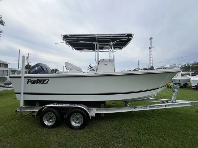 Slide: The Image of A 2027 Parker 210 Coastal boat on a trailer, set on a grassy field. - 5