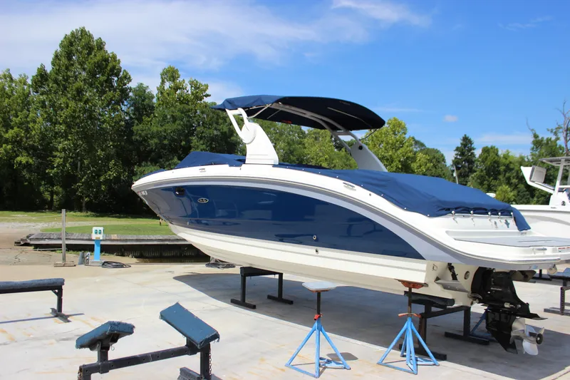 Slide: The Image of 2019 Sea Ray SDX 290 boat on stands, blue and white design, outdoor setting. - 3
