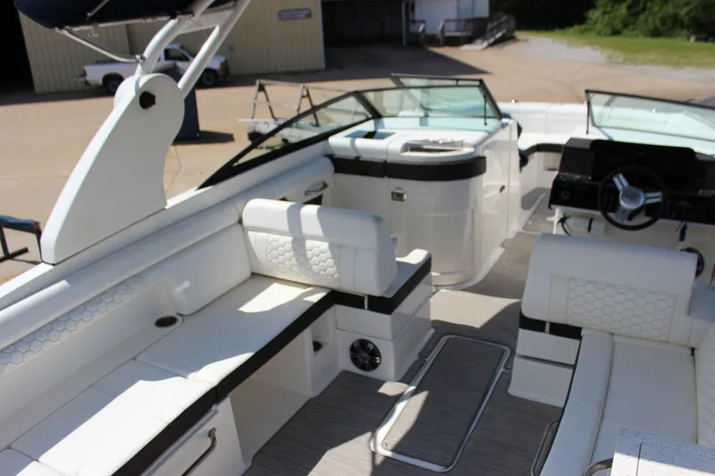 Slide: The Image of 2019 Sea Ray SDX 290 boat interior with white seating and modern dashboard. - 36
