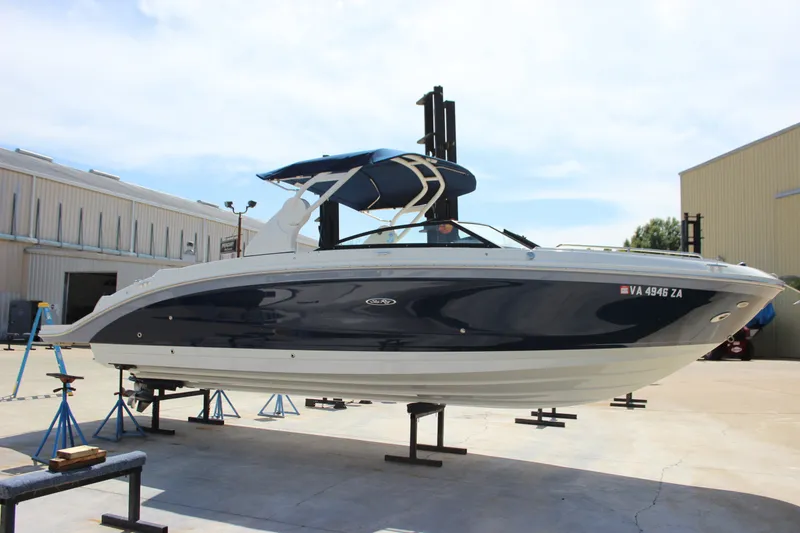 Slide: The Image of 2019 Sea Ray SDX 290 boat on stands in a marina setting. - 24