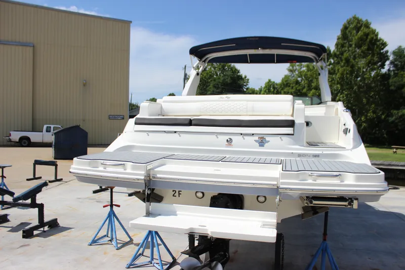 Slide: The Image of 2019 Sea Ray SDX 290 boat on stands, rear view, outdoors. - 16