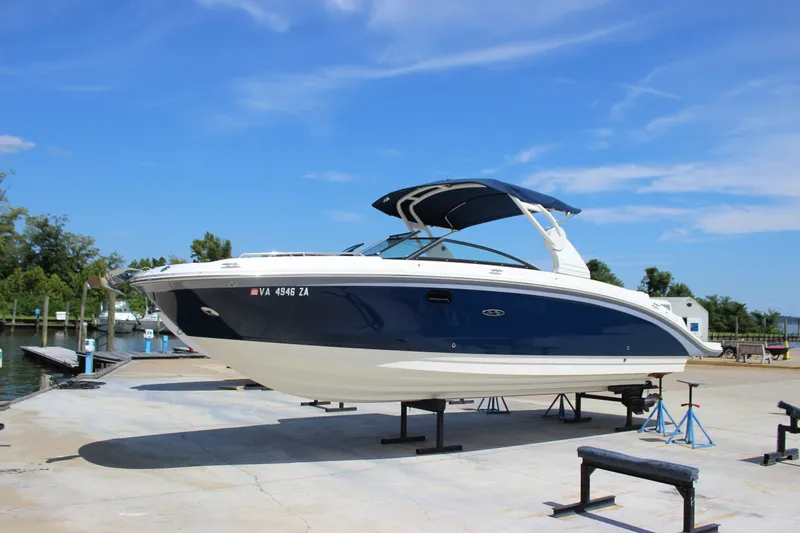 Slide: The Image of 2019 Sea Ray SDX 290 boat on dry dock under clear blue sky. - 20
