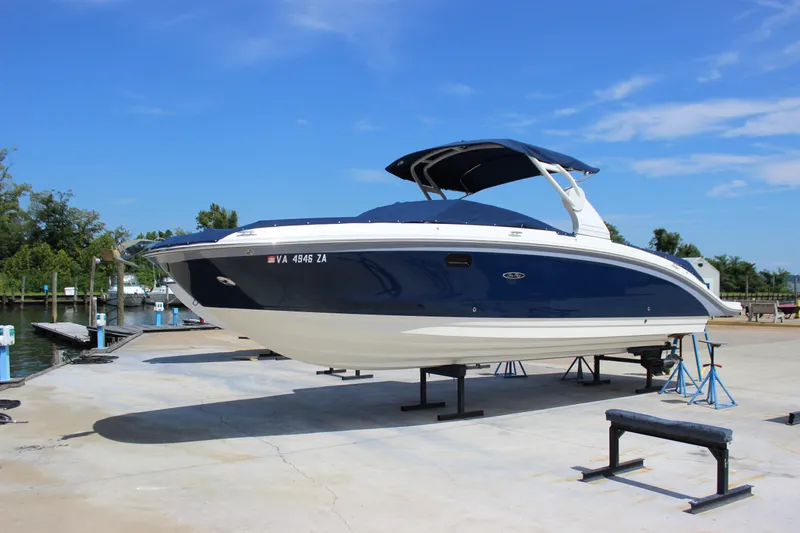 Slide: The Image of 2019 Sea Ray SDX 290 boat on dry dock under clear blue sky. - 1